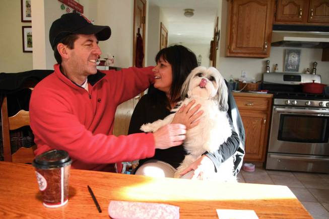 Douglas and Nancy Whitney and their dog, Zoey, at the kitchen table in their house, which is on a bypass road in Foxborough. They vehemently oppose construction of a casino -- he for moral reasons, she because of the crime, drugs, prostitution and traffic she believes it will bring to the town.